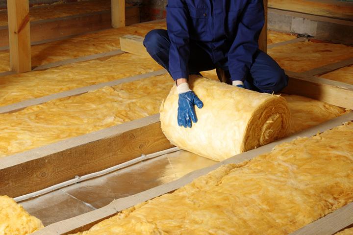 Contractor insulating home attic.