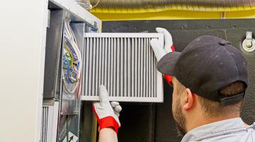 HVAC Tech replacing air filter
